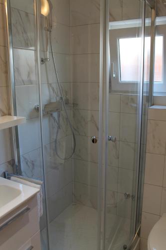 a bathroom with a shower with a glass door at Villa Bougenvilia Tomas in Tučepi