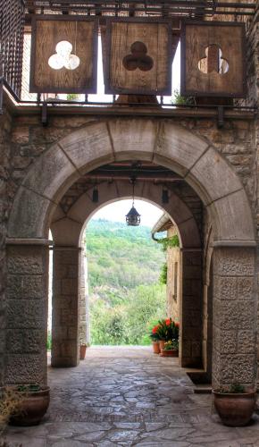 an archway with an entrance to a building with a view at Agriturismo Castello Di Belforte in Todi