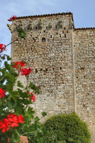 a brick building with a window and red flowers at Agriturismo Castello Di Belforte in Todi