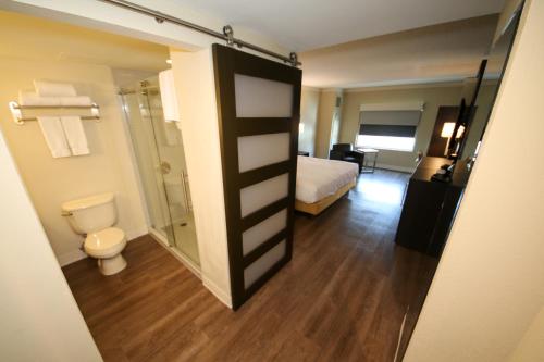 a hotel room with a bathroom with a toilet and a shower at Hollywood Casino St. Louis in Maryland Heights