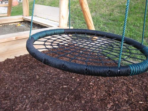 a black tire on a swing in a yard at Apartments Frechhof in Schladming