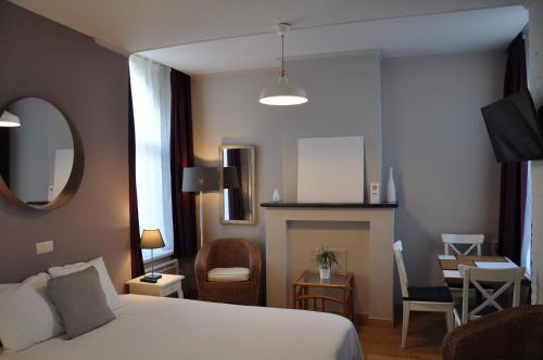 En eller flere senger på et rom på Hotel Bon Accueil