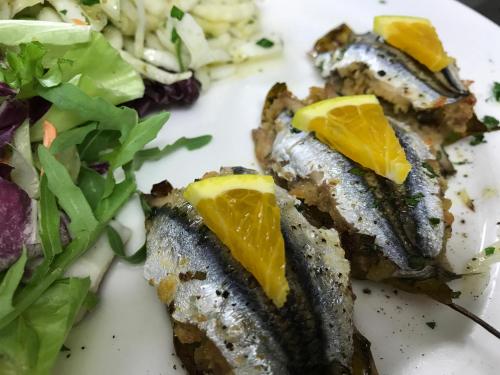 a plate of food with fish and a salad at Giardino Di Sicilia in SantʼAgata di Militello