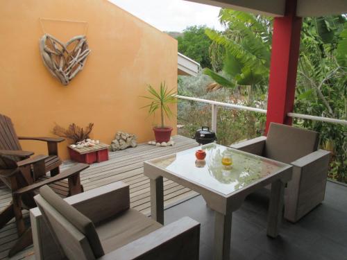 a patio with a table and chairs on a deck at Don Genaro Apartments in Barber