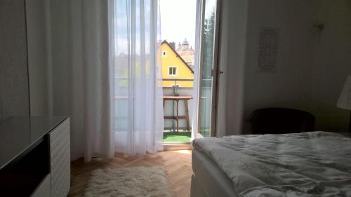 a bedroom with a bed and a large window at Am Löwenpark in Melk