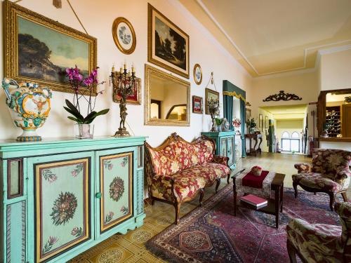 a living room with a couch and a table at Hotel Sirius in Taormina
