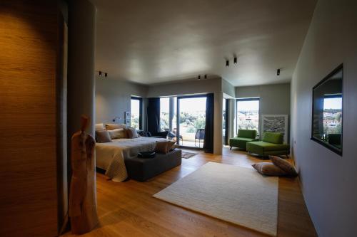 a bedroom with a bed and a living room with a couch at Boutique Hotel Valsabbion in Pula