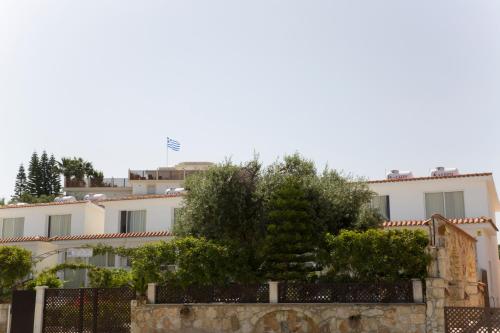 a group of buildings with trees in the foreground at Eliofos Elegant Maisonettes in Polis Chrysochous