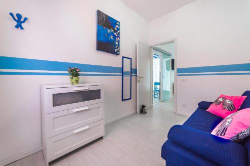 a living room with a blue couch and a tv at The 727 Sottomarina in Sottomarina