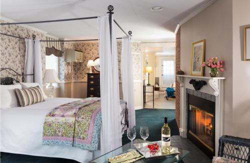 a hotel room with a bed and a fireplace at Rabbit Hill Inn in Lower Waterford