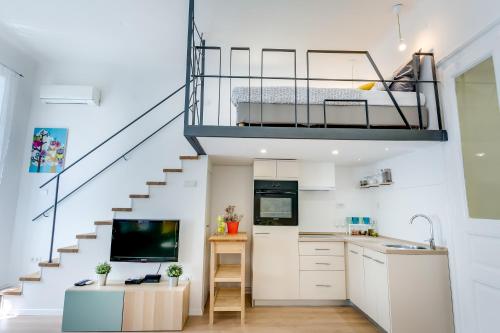a room with a kitchen and a loft bed at Studio Go2Zagreb in Zagreb