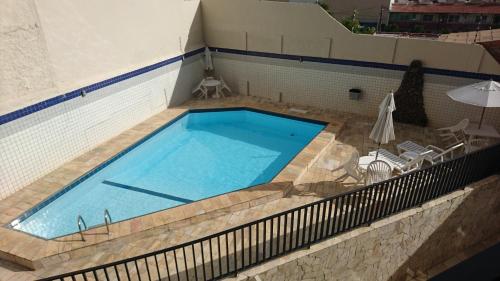 a large swimming pool with a fence around it at Apartamento Atalaia Aracaju in Aracaju