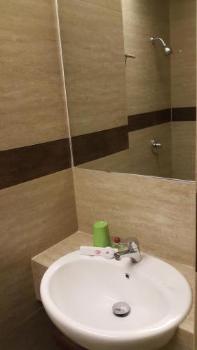 a white sink in a bathroom with a mirror at BIZ HOTEL City Center in Ambon
