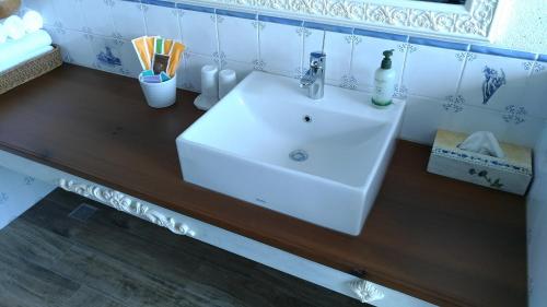 a bathroom with a white sink on a wooden counter at Charmole in Wujie