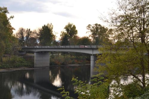 a bridge over a river with a train on it at The Lodge at Riverside in Grants Pass