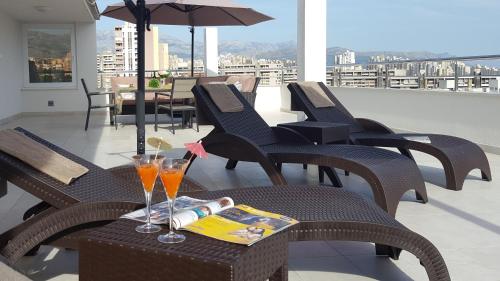 a table with two glasses and a magazine on a balcony at Three Roses in Split