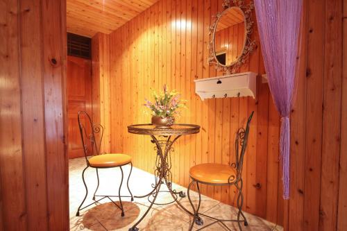 a table and two chairs in a room with wooden walls at Pomelo B&B in Dongshan