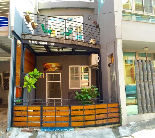 a building with a balcony with plants on it at Kenting Lian Nan Wan in Nanwan