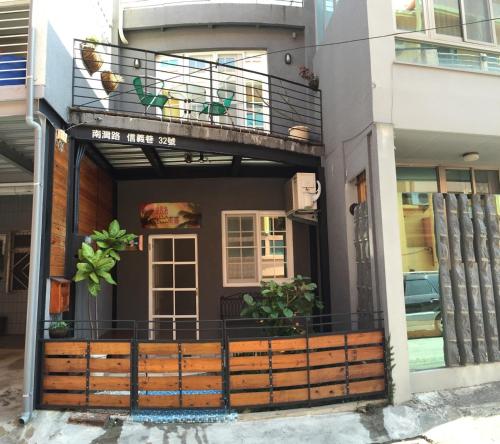 a building with a balcony with plants on it at Kenting Lian Nan Wan in Nanwan
