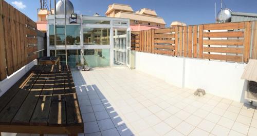 a balcony of a house with a bench on it at Kenting Lian Nan Wan in Nanwan