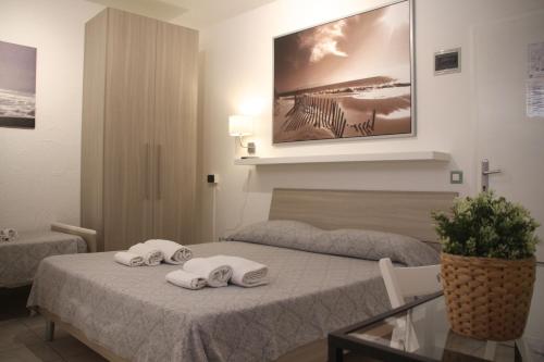 Postel nebo postele na pokoji v ubytování All'Etrusconia Hotel Castagneto Carducci