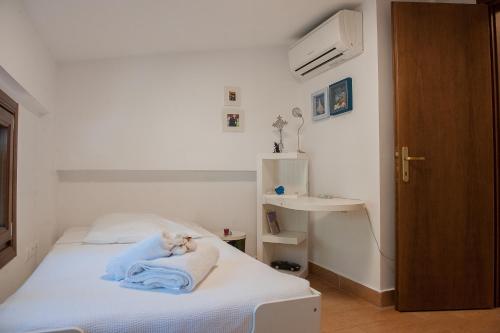 a bedroom with a bed with a towel on it at Naftilos Villa Sani with private Pool in Sani Beach