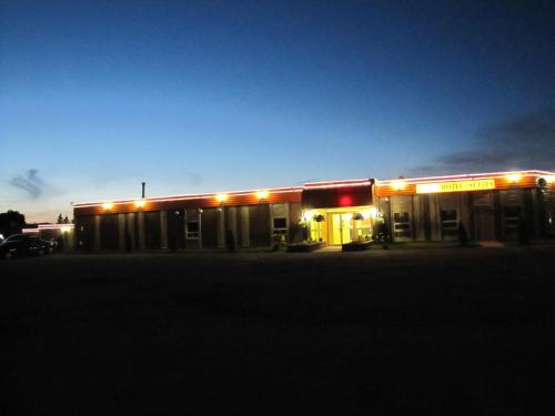 a gas station with lights in a parking lot at Valley Inn Motel in Sudbury