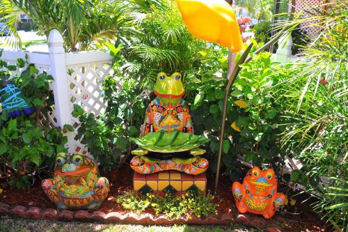 a large colorful statue in a garden with plants at Blue Seas Courtyard in Fort Lauderdale