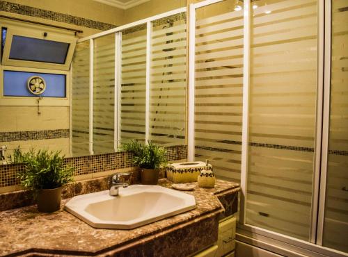 a bathroom with a sink and a shower at Shata Apartment - Families Only in Cairo