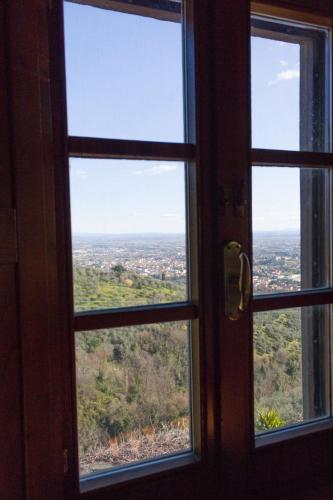 a window view of a city seen through it at Affittacamere Adri in Uzzano