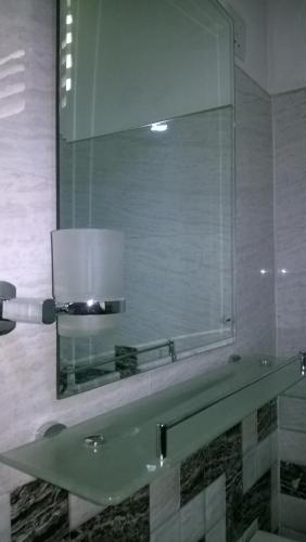 a bathroom with a sink and a large mirror at Danara Homestay in Sigiriya