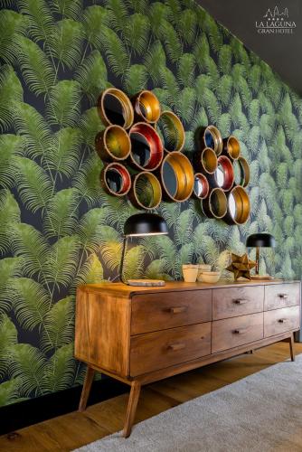 a dresser with plates and lamps on a wall at La Laguna Gran Hotel in La Laguna