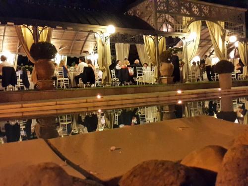 a room with people sitting at tables in a restaurant at Hotel Villa Beccaris in Monforte dʼAlba