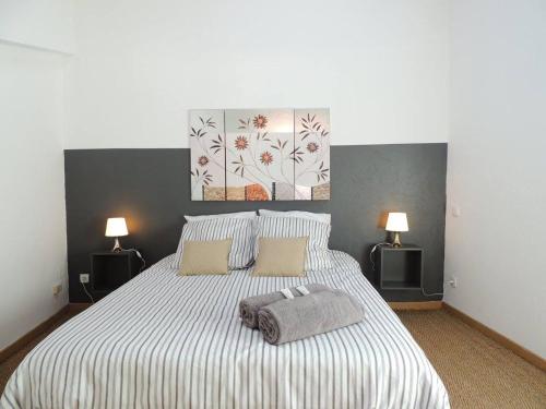 a bedroom with a bed with two pillows and two lamps at Provence Verdon in Tavernes