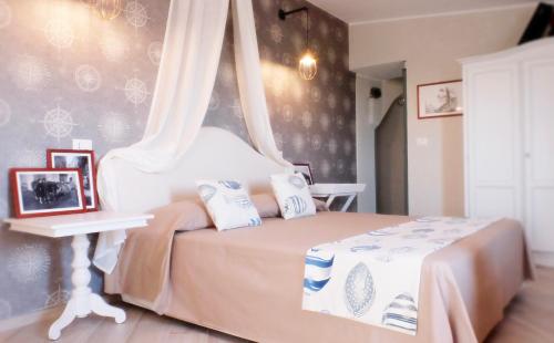 a bedroom with a bed with a canopy at Dal Patriarca in Imperia