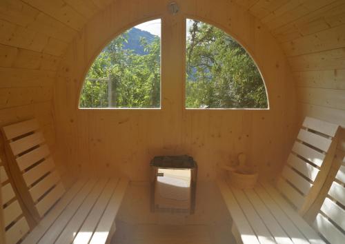an inside view of a wooden room with two windows at Hotel Pension Verdorfer in Merano