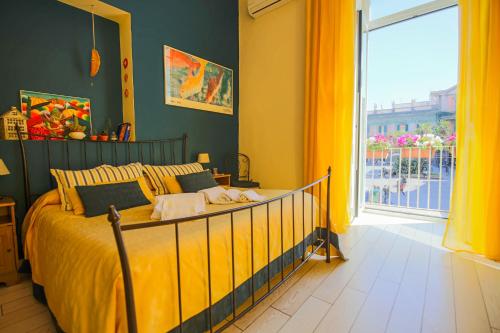 a bedroom with a bed and a large window at Bed & Breakfast Piazza Dante in Naples