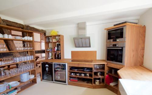 a large kitchen with wooden cabinets and shelves at Wilhelmshof Feggendorf in Feggendorf