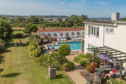 an aerial view of a house with a swimming pool at Beau Vallon Holiday Apartments in St Pierre du Bois