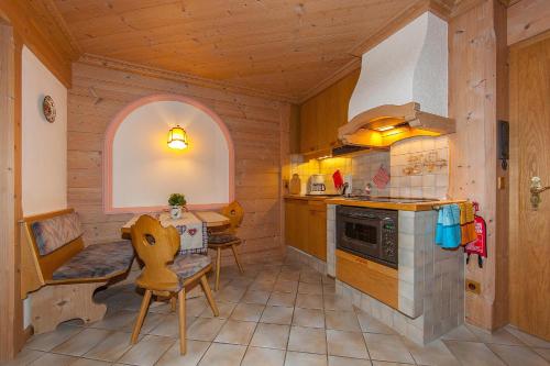 a kitchen with a stove and a table in a room at Gästehaus Lipp in Mittenwald