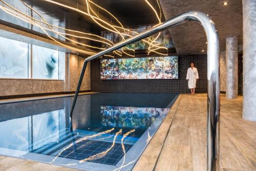 a woman standing in a hot tub in a building at Novotel London Canary Wharf in London