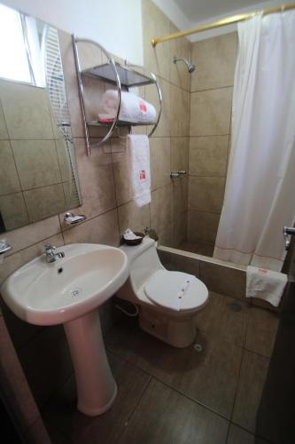 a bathroom with a sink and a toilet and a shower at Hotel B´liam in Tumbes