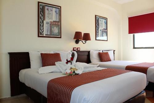 A bed or beds in a room at Hotel Residencial