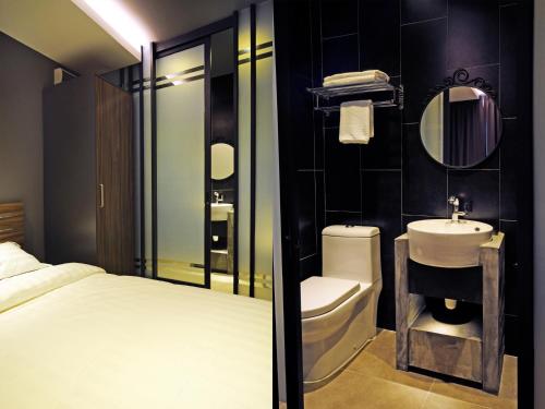 
a bathroom with a toilet, sink, and shower at Hotel 1915 Kuala Lumpur in Kuala Lumpur
