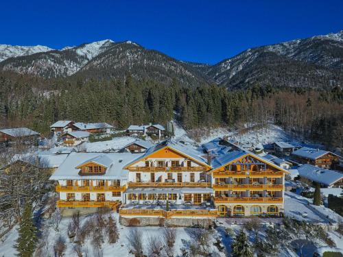 an aerial view of a resort with snow covered mountains at Romantik Alpenhotel Waxenstein in Grainau