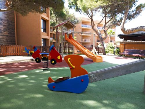 a playground with a slide and toy animals on it at Protur Turo Pins 4* SUP in Cala Ratjada