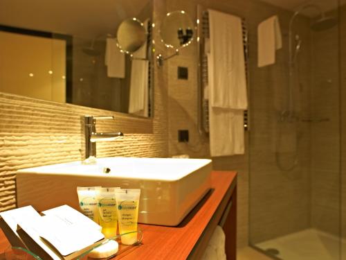 a bathroom with a sink and a shower at Protur Turo Pins 4* SUP in Cala Ratjada