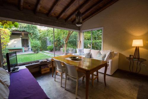 a living room with a table and a couch at Casa Lila in Mendoza