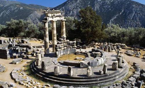 a group of ruins in front of a mountain at Helicon Muses Friendly Mountain B&B Guesthouse in Evangelístria