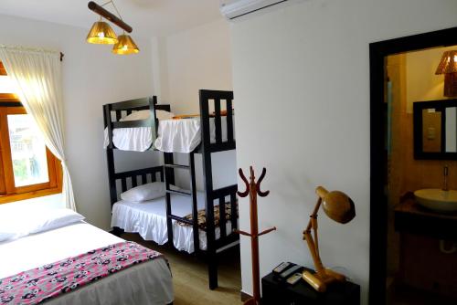 a bedroom with a bed and a bunk bed at Hotel Sotavento in Montañita